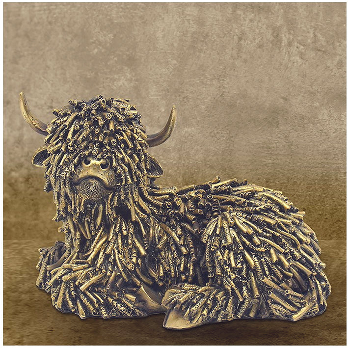 Gold coloured shaggy Highland Cow, Lying Down