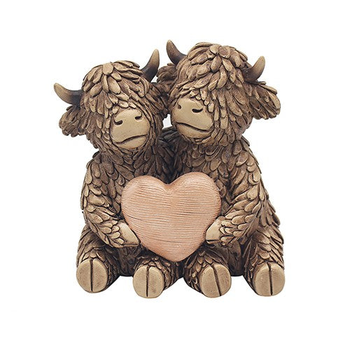 Hughie the Highland Cow,sitting with friend and heart ornament