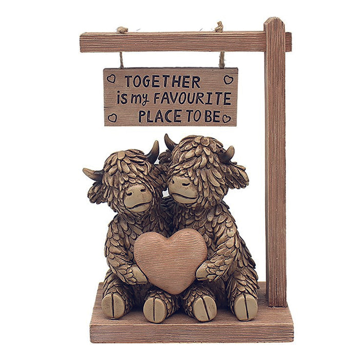 Hughie the Highland Cow couple under sign reading Together is my favourite place to be