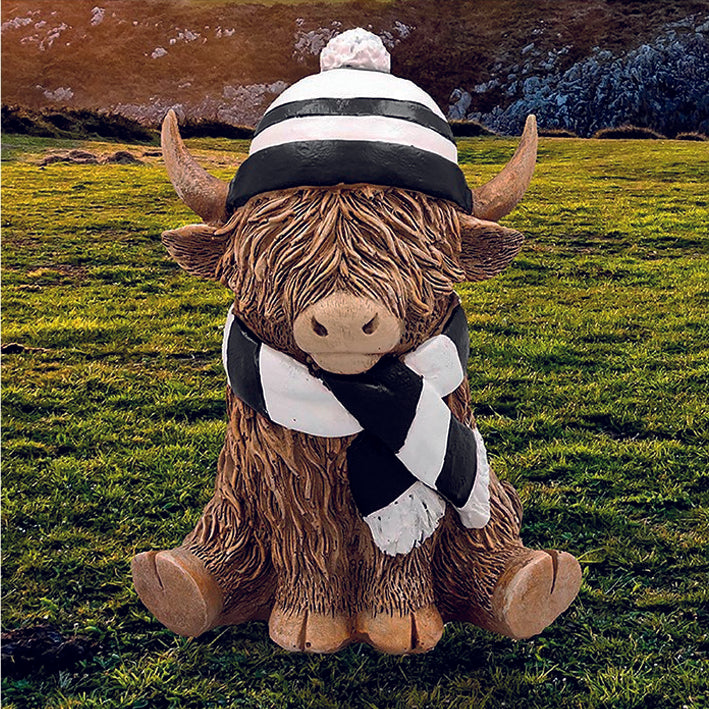Happy Highland Cow with a black and white hat and scarf