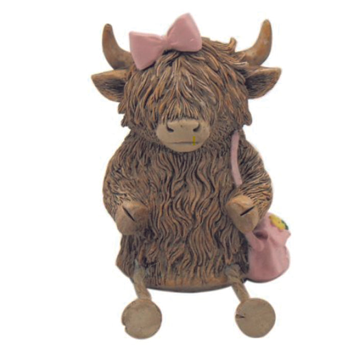 Hughie the Highland Cow ornament, sitting with pink bow and bag and dangly legs