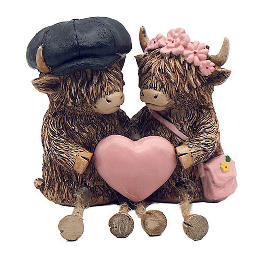 Hughie the Highland Cows, sitting couple heart ornament and dangly legs