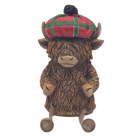 Hughie the Highland Cow ornament, sitting with tartan hat and dangly legs