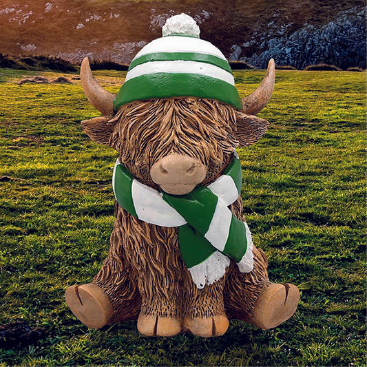 Happy Highland Cow with a green and white hat and scarf