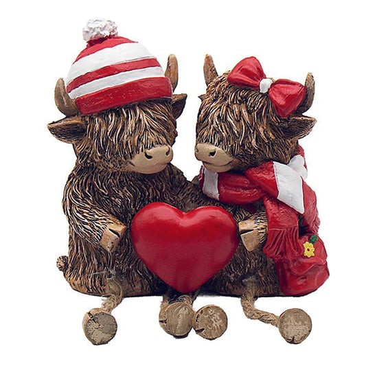 Happy Highland Cow Couple with Red and White Hats and Scarves