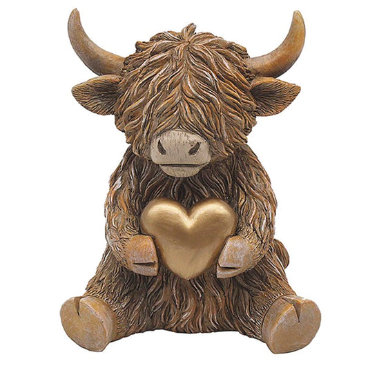 Happy Highland Cow Sitting Holding a Gold Heart