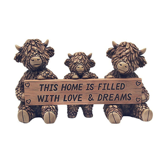 Hughie the Highland Cow and family holding sign reading This Home is Filled with Love and Dreams