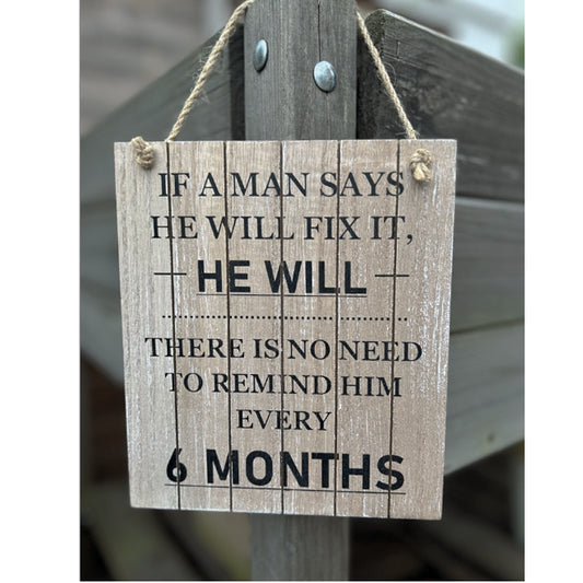 Hanging wooden sign.  If a man says he will fix it...