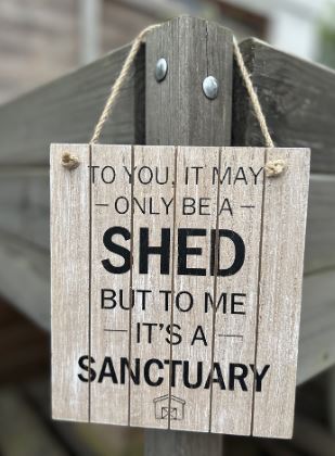 Hanging wooden sign.  To you it may only be a shed, but to me it is a sanctuary