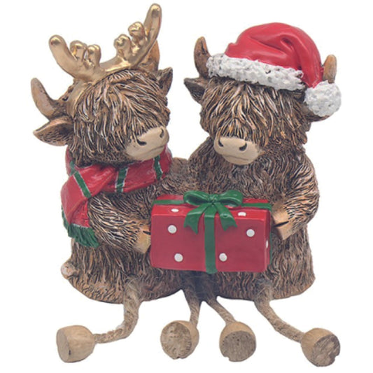 Highland Cows, sitting couple with a Christmas parcel and dangly legs